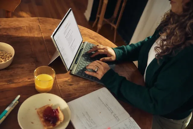 woman typing on laptop